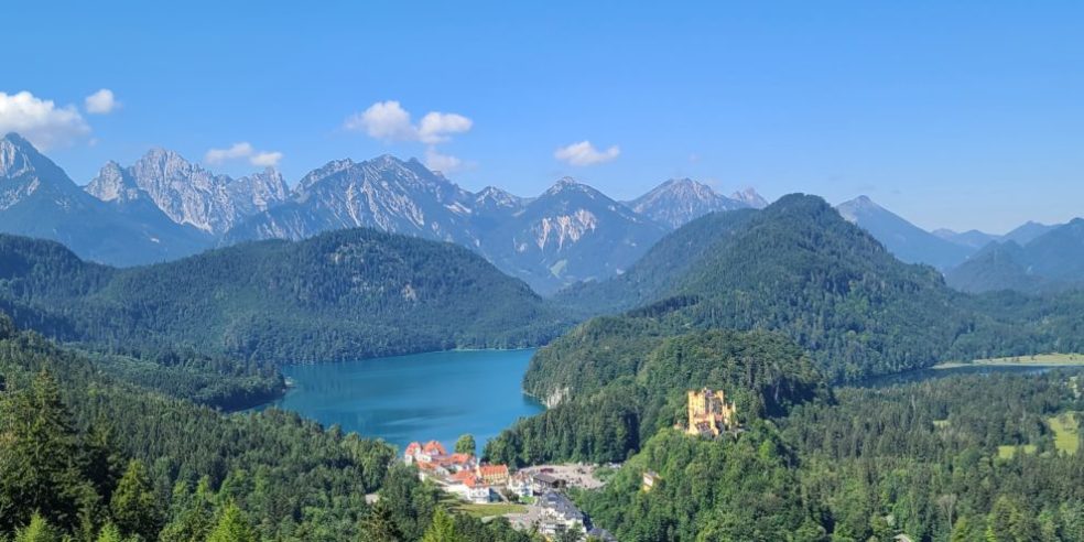 View of the Tyrolean Mountains, Lake Alpsee, and the Castle of Hohenschwangau, travel Germany, German castles