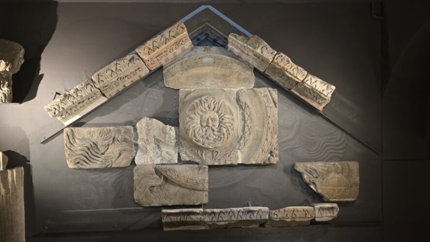 The Temple pediment and Gorgon's head displayed inside The Roman Baths
